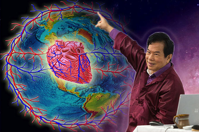 Master Mantak Chia livestreaming his Taoist teachings online while pointing to an image of a Heart and veins wrapped around Planet Earth